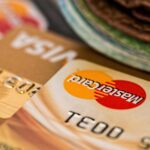 Macro shot of credit cards showing Visa and Mastercard logos next to a wallet, ideal for finance themes.